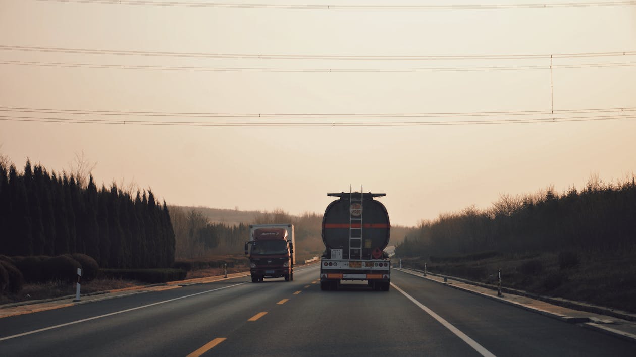 Long haul trucks on a highway at dusk
